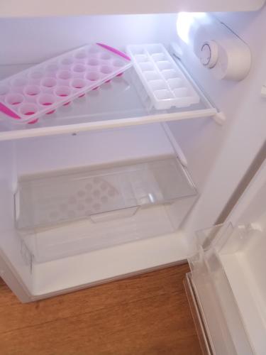 an empty refrigerator with its door open and itsartmentsearch at Sunrise Caravan in Dymchurch