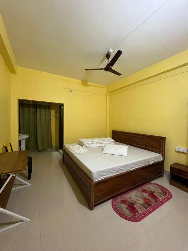 a bedroom with a bed and a ceiling fan at Hotel Diyo inn in Guwahati