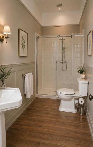 a bathroom with a shower and a toilet and a sink at Le clos joli in Saint-Saviol