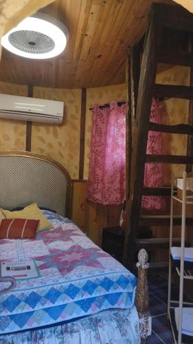 a bedroom with a bed and a wooden ceiling at Chambre de la Tour 1 in Milhac