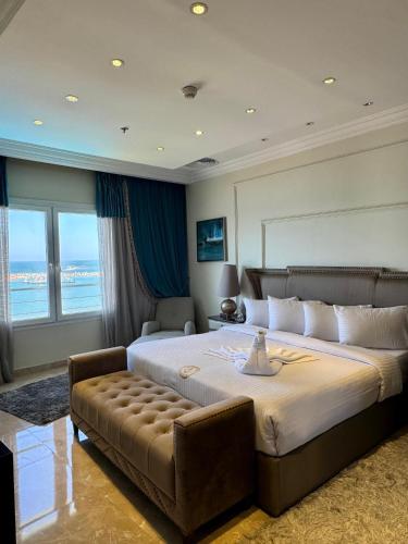 a large bedroom with a large bed and a couch at Fleet Club Mahrousa in Alexandria