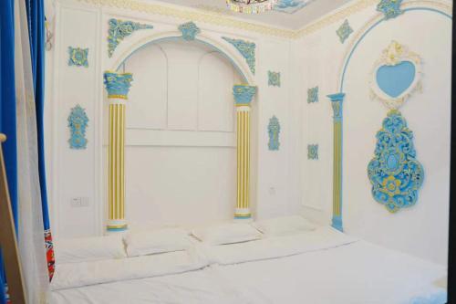 a white room with columns and a wall with a room with at 巷子民宿 in Kashgar
