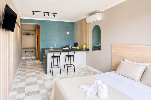 a hotel room with a bed and a kitchen at BayShore Lofts in Cabo Frio