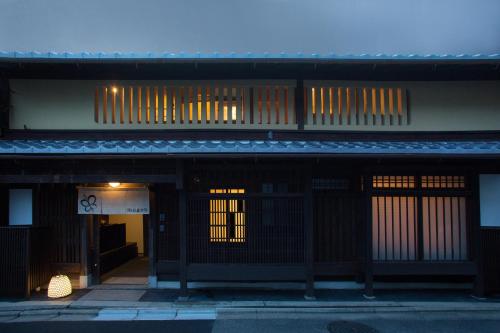 
a building with a large window and a clock on it at Ryokan Mugen (Adult Only) in Kyoto

