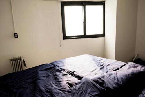 a bedroom with a bed and a window at That House Hongdae in Seoul