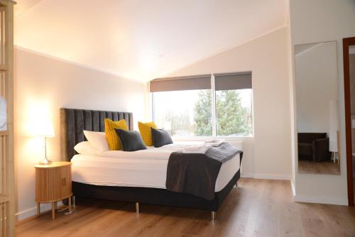 a bedroom with a large bed with a window at Hotel Hvolsvollur - Central South Iceland in Hvolsvöllur
