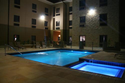 a swimming pool in front of a building at night at Hampshire Hotel - Ballito in Ballito