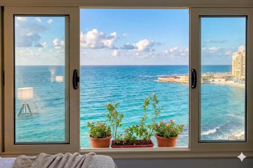 a window with a view of the ocean at Nour 1 Sea View Apartment in Alexandria