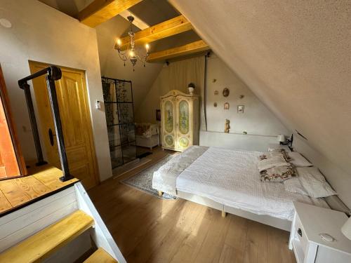 a bedroom with a white bed in a attic at Saschiz 130/Lodging and Glamping in Saschiz