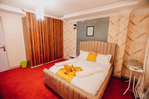a bedroom with a bed with a yellow bow on it at Rouse precious haven in Nakuru