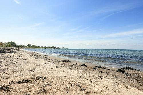 a sandy beach with the ocean in the background at Holiday Home With A Direct Path To The Sea in Korsør