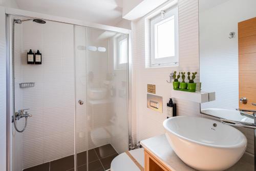 a bathroom with a sink and a toilet and a shower at No 14 HOTEL GÖCEK in Göcek