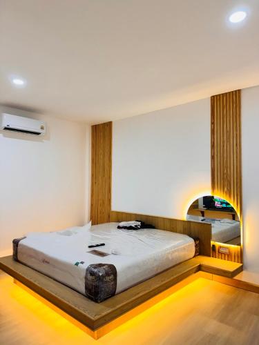 a bedroom with a large bed in a room at Meena boutique in Ban Nai Wat