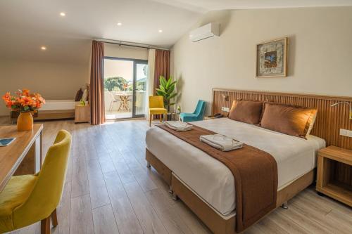 a bedroom with a large bed and a table and chairs at No 14 HOTEL GÖCEK in Göcek