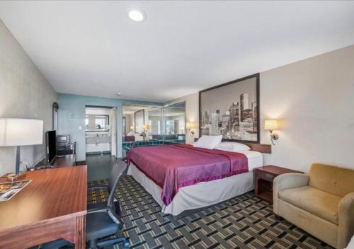 a hotel room with a bed and a desk at Hotel Blue Baytown, Texas in Baytown