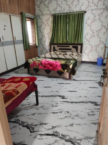 a bedroom with two beds with flowers on the floor at Shashtri nagar AC homestay in Kolhapur