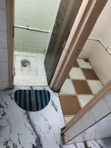 a dirty bathroom with a toilet in a room at Shashtri nagar AC homestay in Kolhapur