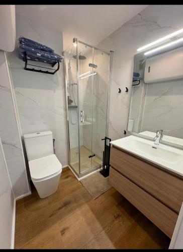 a bathroom with a shower and a toilet and a sink at Nook arenal Jávea in Platja de l'Arenal