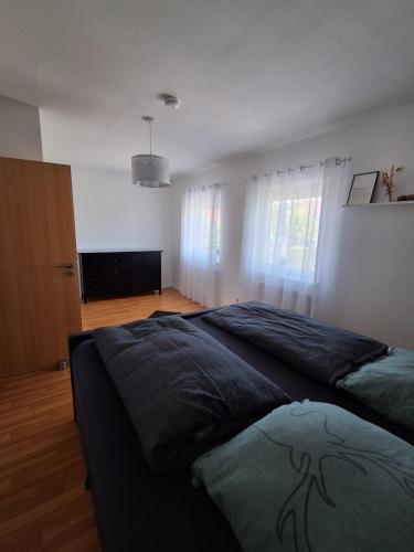 a bedroom with a bed in a room with a window at Fonso's Garden in Freudenstadt