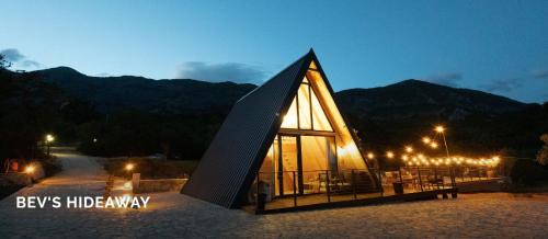 a building with a triangular roof at night at BEV's Hideaway in Gornji Kosići