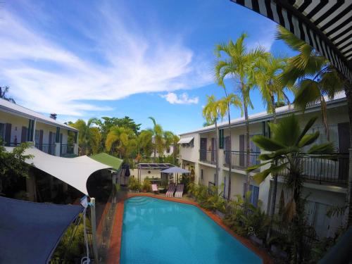 a beach with a pool and a balcony at Crystal Garden Resort & Restaurant in Cairns