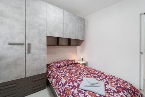 a bedroom with a bed and a large cabinet at Casa Cortina in Domodossola