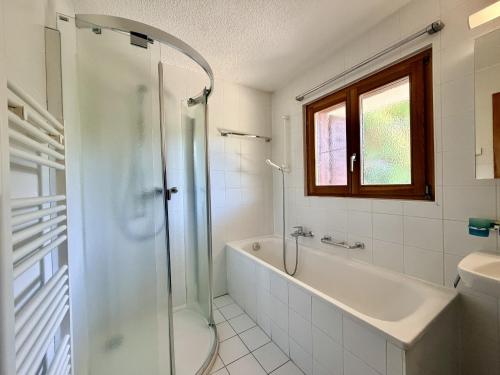 a bathroom with a shower and a tub and a sink at Eanta SUNNY & MOUNTAIN chalet 10 pers by Alpvision Résidences in Veysonnaz