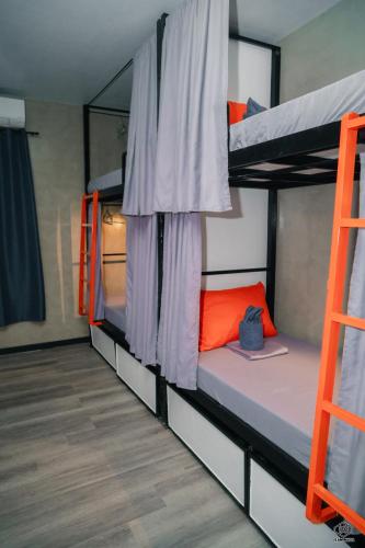 a room with two bunk beds and a ladder at Luna Vista Tourist Inn in Puerto Princesa City