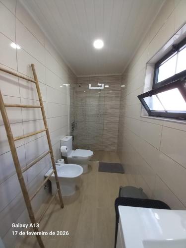 a bathroom with two toilets and a window at Apartamento do Chico in Terra Chã