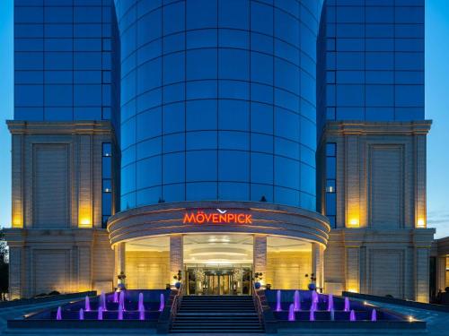 a building with a sign in front of it at Mövenpick Samarkand in Samarkand