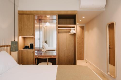 a bedroom with a bed and a desk in a room at Hotel Apollon Corfu in Paleokastritsa