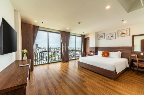 a hotel room with a bed and a balcony at Dian Hotel & Apartment in Danang