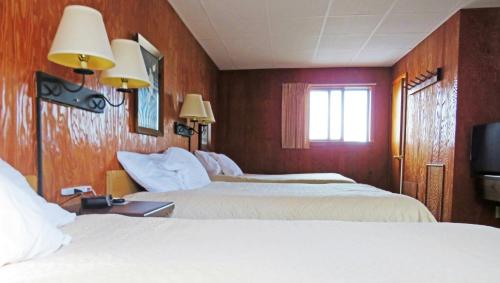 a hotel room with two beds and a window at Indianhead Ironwood Hotel in Ironwood