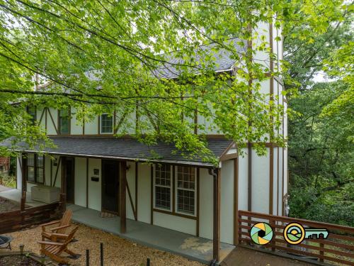 a white house with a porch and a fence at Lakeview 10B: Forest Den in Basye