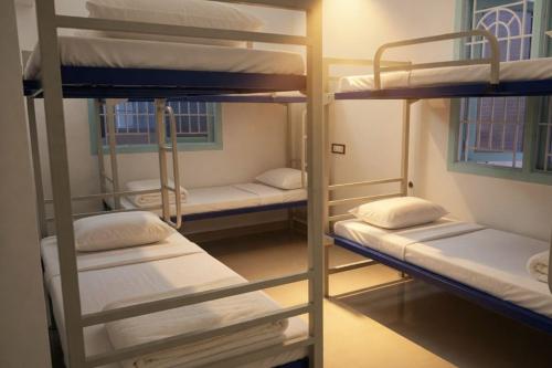 a group of bunk beds in a room at Kattil Chennai in Chennai