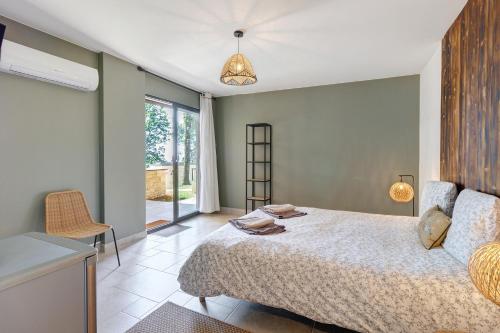 a bedroom with a bed and a room with a window at Le Pech Eternel - La Sablière in Sarlat-la-Canéda
