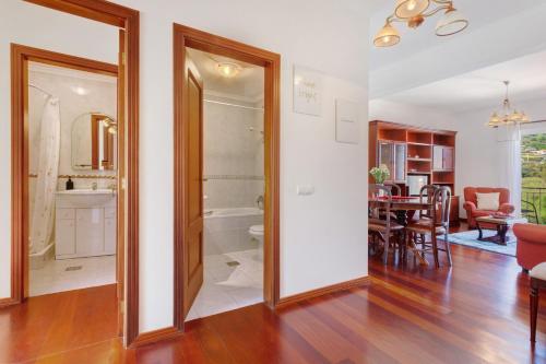 a living room with a kitchen and a dining room at Paradise Dream in Caniço