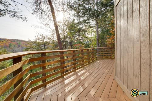 a wooden deck with trees in the background at Villa #162 in Basye