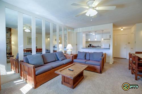 a living room with two blue couches and a table at Aspen East Unit #122 in Basye