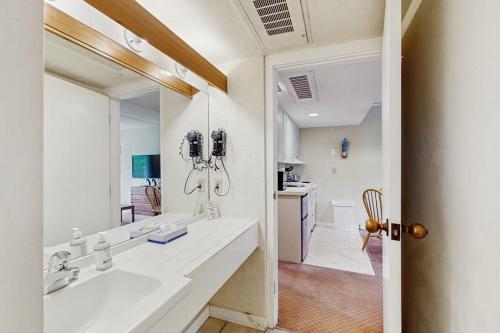 a bathroom with a sink and a large mirror at Seasons 200 in Warren
