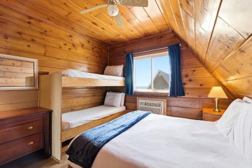a bedroom with two bunk beds in a wooden cabin at Chalet #16 in Stevensville