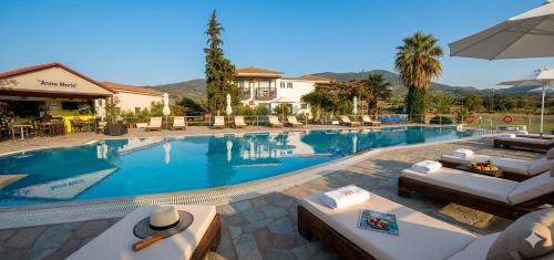a swimming pool with lounge chairs and a resort at Annamaria Studios & Apartments in Petra
