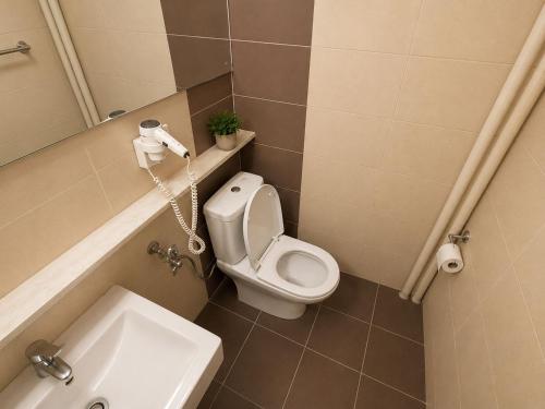 a small bathroom with a toilet and a sink at The Square Central Prishtina in Prishtinë