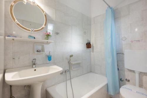 a bathroom with a sink and a mirror and a shower at Apartment with sea view - Creta in Ferma