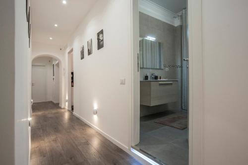 a hallway leading to a kitchen with white walls at Magia in Trastevere in Rome