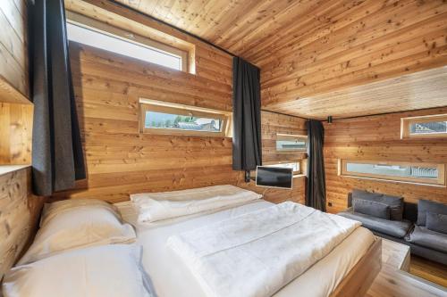 a bedroom with a bed in a wooden wall at Design Lodge The Cube in Ortisei
