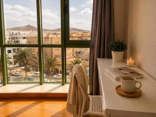 a room with a table and a large window at Villa María Arrecife Beach in Arrecife