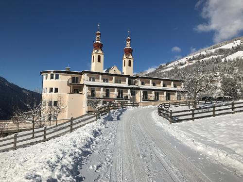 a building with two towers on a snow covered mountain at Fliess Apartment in Fliess