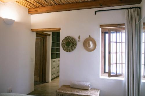 a living room with white walls and a window at Vineyard Cottage at Bosman Wines in Wellington
