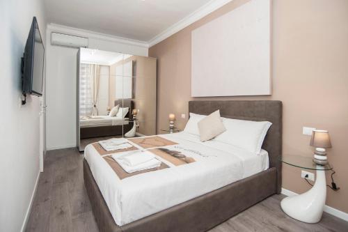 a bedroom with a large bed and a living room at Magia in Trastevere in Rome